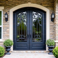 Arched Double Door With Black Wrought Iron, Glass Panels, and Stone Surround