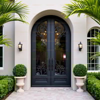 Arched Double Door With Wrought Iron Glass, Dark Frame, and Sconce Lighting