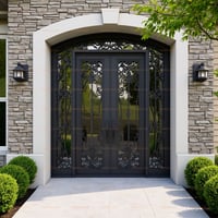 Arched Double Doors With Intricate Metalwork and Glass, Flanked by Stone and Lanterns