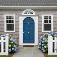 Arched Blue Paneled Door With Brass Hardware and Decorative Transom Window