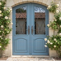 Arched Blue Double Doors With Wrought Iron and Stone Archway