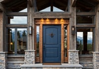 Arched Blue Entry Door With Iron Knocker and Sidelights