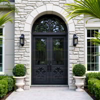 Elegant Arched Double Doors With Ornate Metalwork and Stone Surround