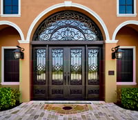 Ornate Wrought Iron and Wood Double Doors With Arched Transom Window 1