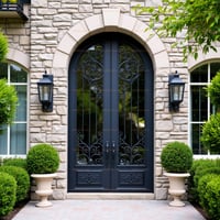 Arched Double Door With Decorative Ironwork and Stone Surround