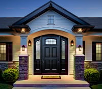 Elegant Black Wood Front Door With Leaded Glass Sidelights and Stone Columns