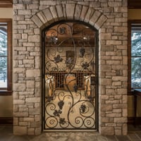 Wrought Iron Wine Cellar Gate With Grape Vine Design in Stone Archway