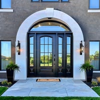 Elegant Arched Black Door With Glass Panes and White Stone Surround