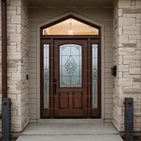 Arched Entry Door With Decorative Glass Sidelights and Stone Columns