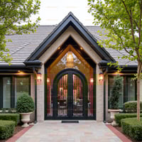 Ornate Arched Double Doors With Black Metalwork and Decorative Glass Design