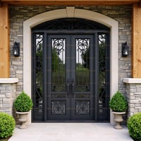 Arched Dark Gray Metal Double Door With Ornate Scrollwork and Keystone